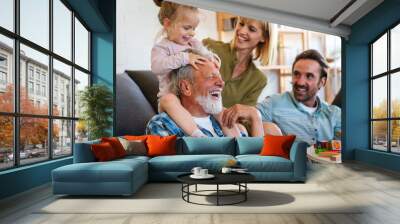 Cheerful multi-generation family having fun while spending time together at home. Wall mural