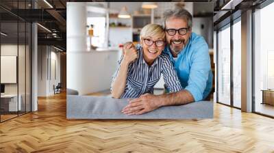 Cheerful senior couple enjoying life together, having fun at home Wall mural