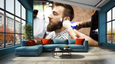 Client during beard and moustache grooming in barber shop Wall mural