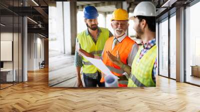 Construction engineers discussion with architects at construction or building site Wall mural