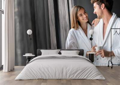 Couple in bathrobes enjoying honeymoon in spa resort Wall mural