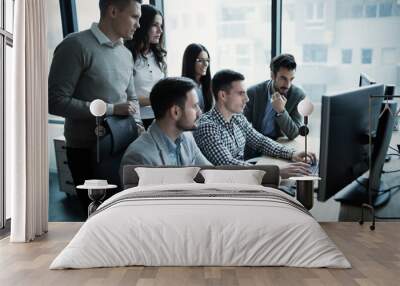 Coworkers working on project together in office Wall mural