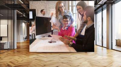 Creative young business people and architects working in office Wall mural