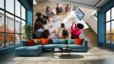 Creative young business people and architects working in office Wall mural