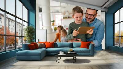 Father and child using digital tablet for e-learning. Education home digital device kid concept. Wall mural