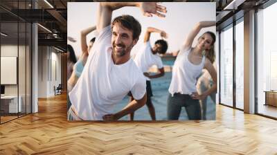 Fitness, sport, friendship and healthy lifestyle concept . Group of happy people exercising Wall mural