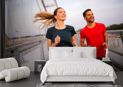 Fitness, sport, people, exercising and lifestyle concept. Couple running outdoor Wall mural