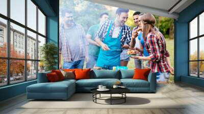 Friends having a barbecue party in nature Wall mural