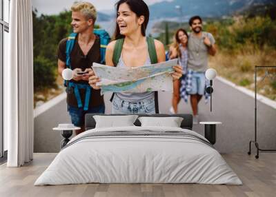 Group of backpackers and young friends traveling and having fun together Wall mural