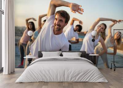 Group of fit healthy friends, people exercising together outdoor on rooftop Wall mural