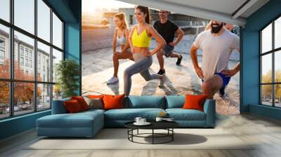 Group of fit healthy friends, people exercising together outdoor Wall mural