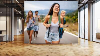 Group of friends backpackers walking and traveling outdoor Wall mural