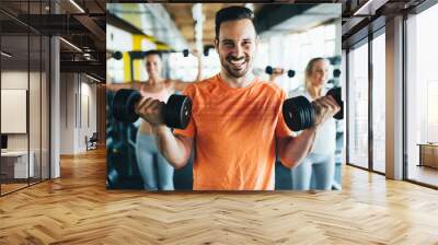 Group of friends exercising together in gym Wall mural