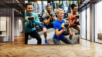 Group of friends smiling and enjoy sport in gym Wall mural