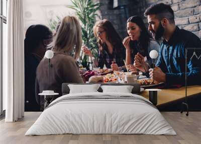 Group of happy business people eating in restaurant Wall mural