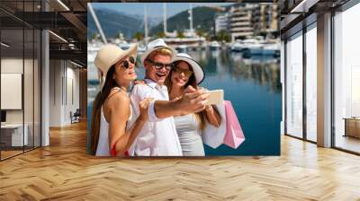 Group of happy friends having fun together on summer vacation, enjoying shopping and travel Wall mural