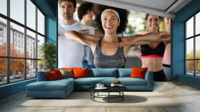 Group of healthy fit people at the gym exercising Wall mural