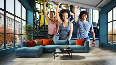 Group of healthy fit people training in gym Wall mural