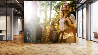 Group of people hiking in forest Wall mural