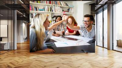 Group of successful happy business people in office celebrating profits Wall mural