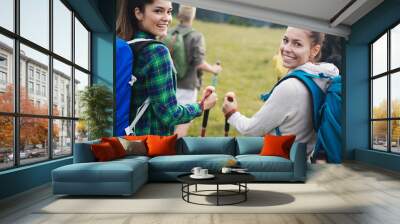 Group of young friends hiking in countryside. Multiracial young people on country walk. Wall mural