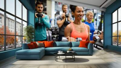 Group of young friends people doing exercises in gym Wall mural