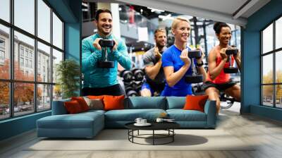 group of young happy fit people doing exercises in gym Wall mural