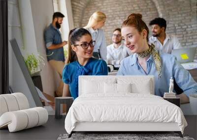 Group of young multi-ethnic startup business team collaborating on project in modern office Wall mural