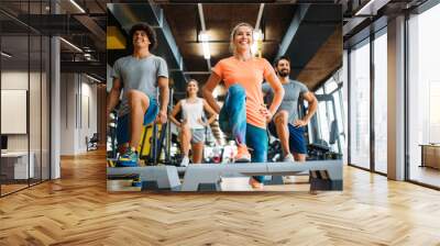 Group of young people doing exercises in gym Wall mural