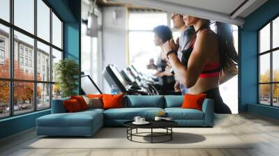 Group of young people exercising on a treadmill at gym Wall mural