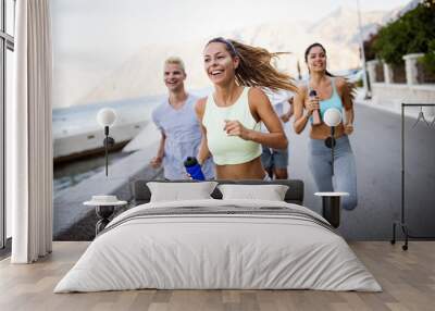 Group of young people jogging and running outdoors in nature Wall mural