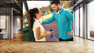 Handsome man and attractive woman talking on court Wall mural