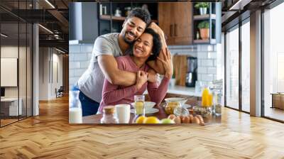 Happy african american couple having breakfast together in the kitchen Wall mural