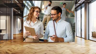 Happy business people, colleagues in modern office working together and using tablet Wall mural