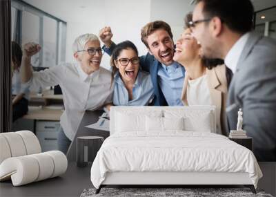 Happy business people celebrating success at company Wall mural