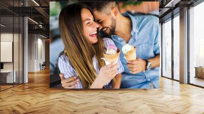 Happy couple having date and eating ice cream Wall mural