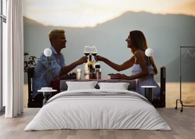 Happy couple on summer evening having romantic dinner outdoor Wall mural