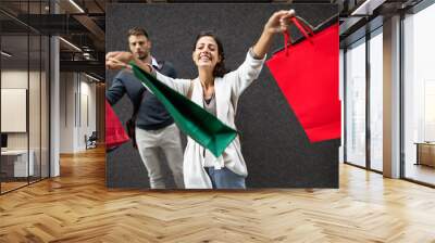 Happy couple with shopping bags. Sale, travel, love consumerism and people concept. Wall mural