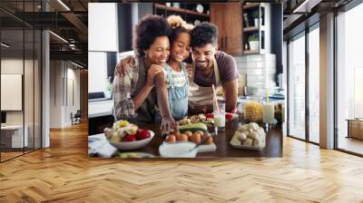 Happy family cooking together food in the kitchen Wall mural