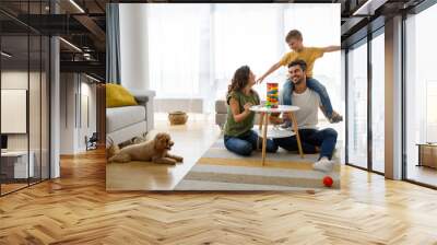 Happy family having fun time, playing together at home with dog Wall mural