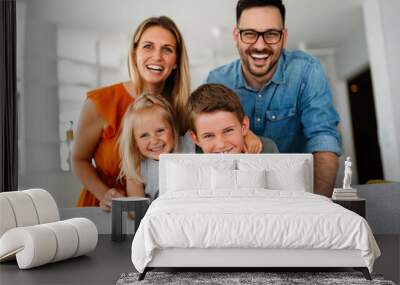 Happy family having fun time at home. Parents playing smiling with childrens together. Wall mural