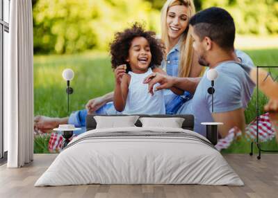 Happy family having fun time on picnic Wall mural