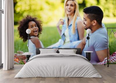 Happy family having fun time on picnic Wall mural