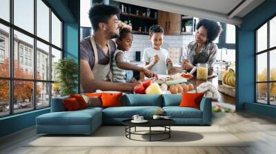 Happy family in the kitchen having fun and cooking together. Healthy food at home. Wall mural