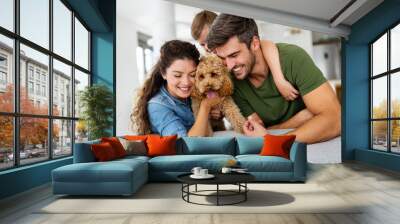 Happy family playing, having fun with dog at home Wall mural