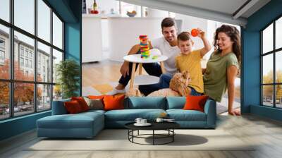 Happy family playing, having fun with dog at home Wall mural