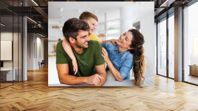 Happy family spending time together, playing at home. Wall mural