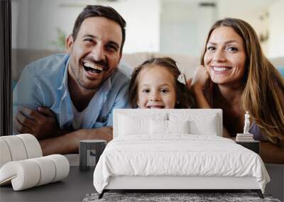 Happy family watching television at their home Wall mural