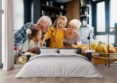 Happy grandchildrens girls having breakfast with her grandparents Wall mural