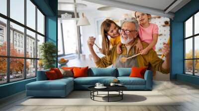 Happy grandparents having fun times with children at home Wall mural